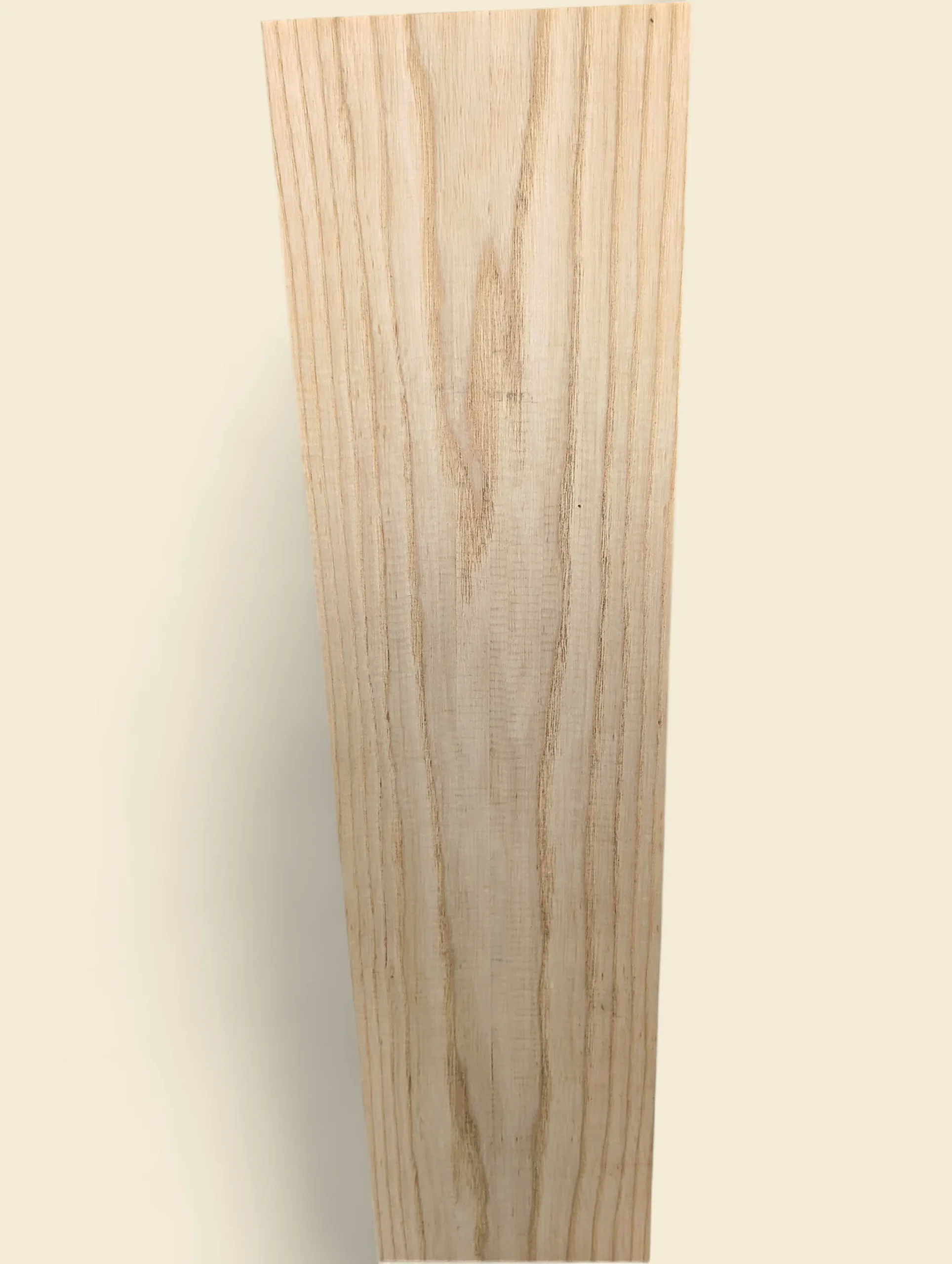 American Ash sawn board, dressed face showing pale straight grain, on linen background