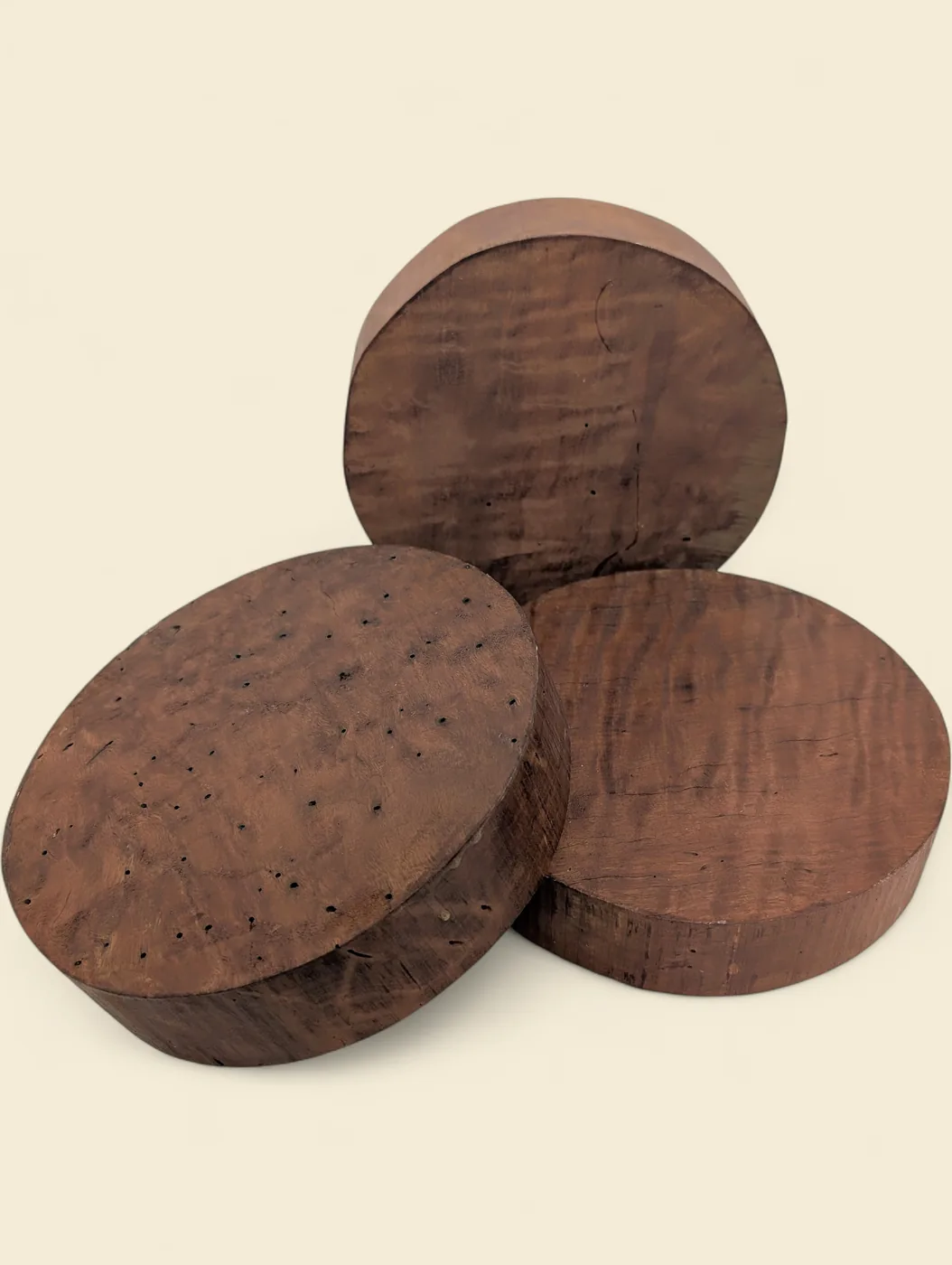 Figured Red Gum bowl blank, 190mm diameter - group of blanks showing colour and figure variation, on linen backdrop