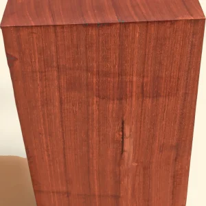 Padauk timber blank, 75 x 200 x 200mm, vivid red-orange, on linen background