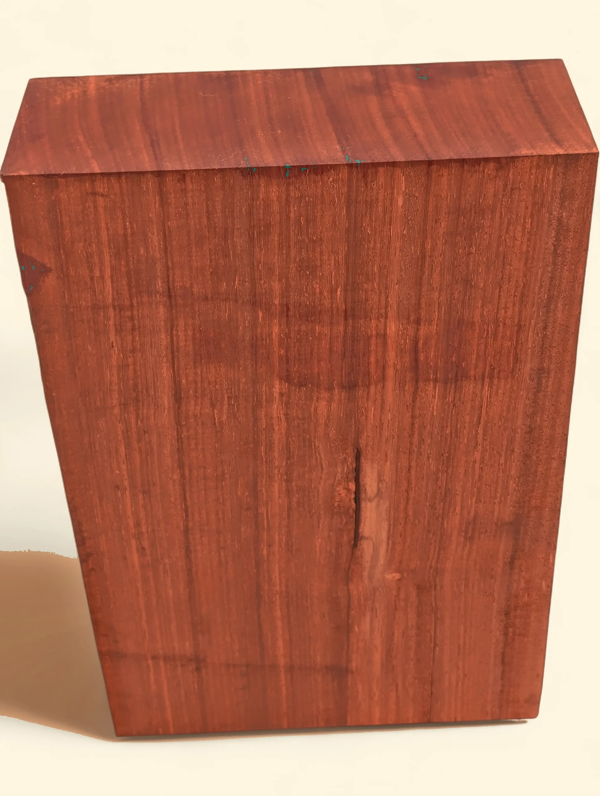 Padauk timber blank, 75 x 200 x 200mm, vivid red-orange, on linen background