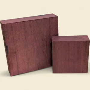 Purple Heart timber blanks, 125mm and 195mm square by 50mm, on linen background