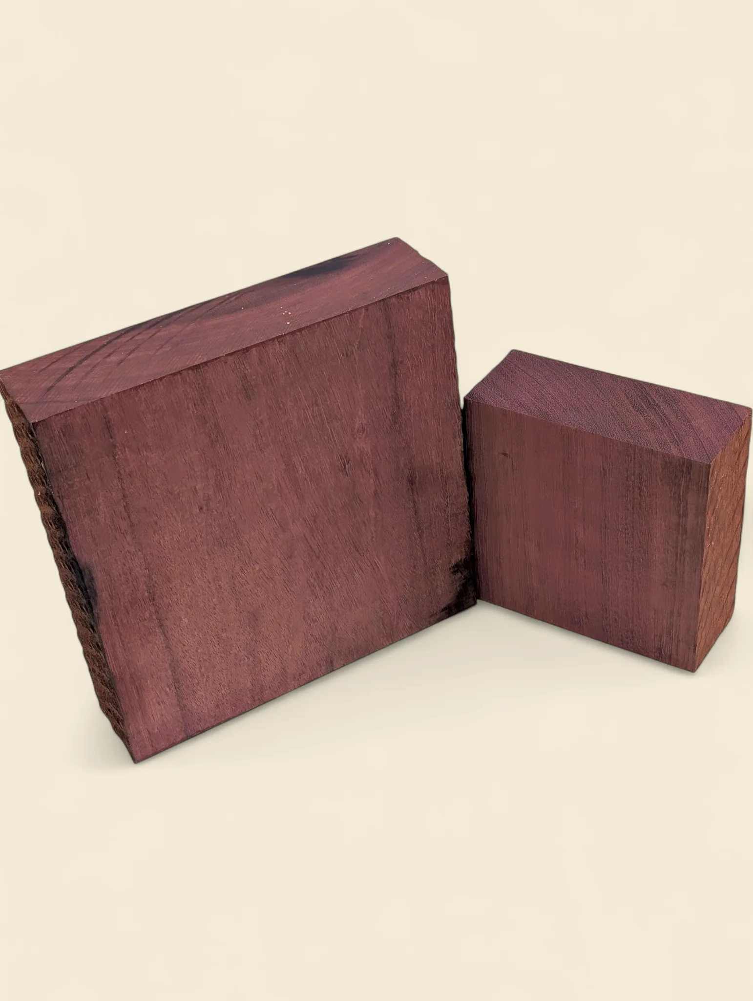 Purple Heart square timber blanks in two sizes on linen background