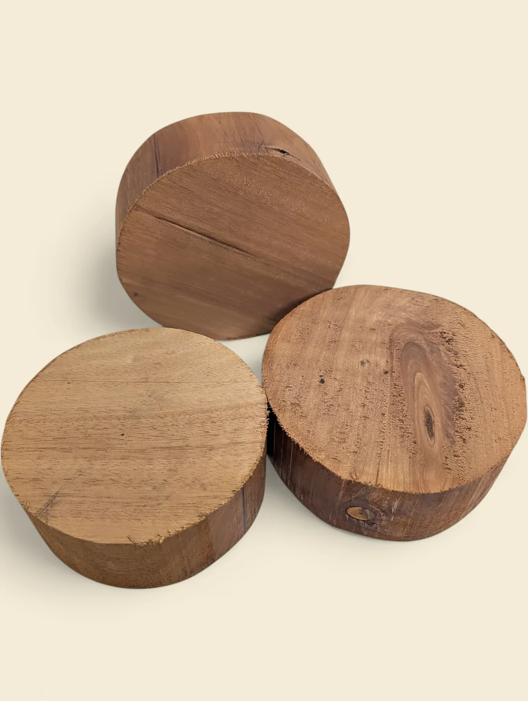 Queensland Maple bowl blank, 110mm diameter - group of blanks showing colour and figure variation, on linen backdrop