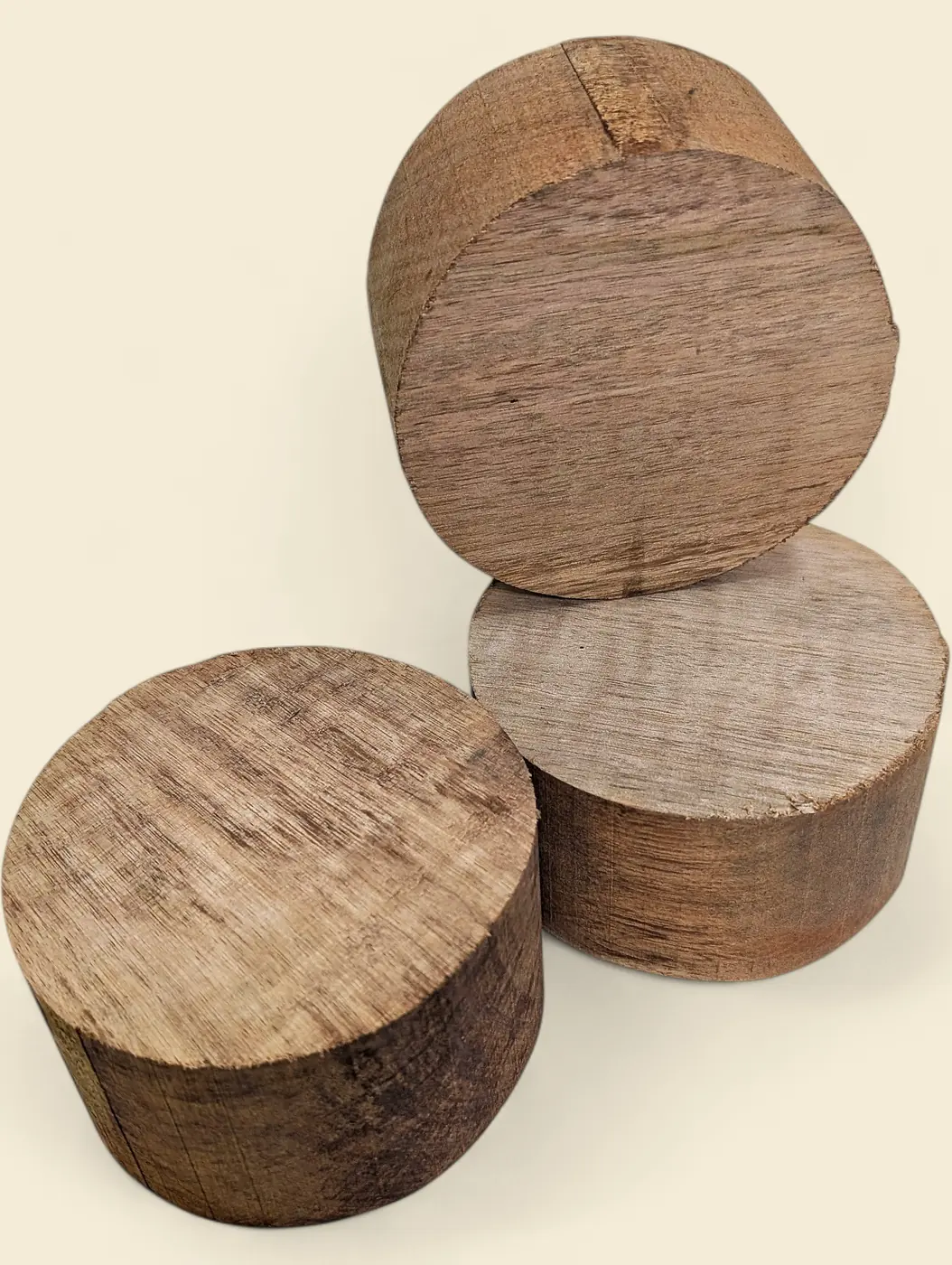 Rose Butternut bowl blank, 120mm diameter - group of blanks showing colour and figure variation, on linen backdrop