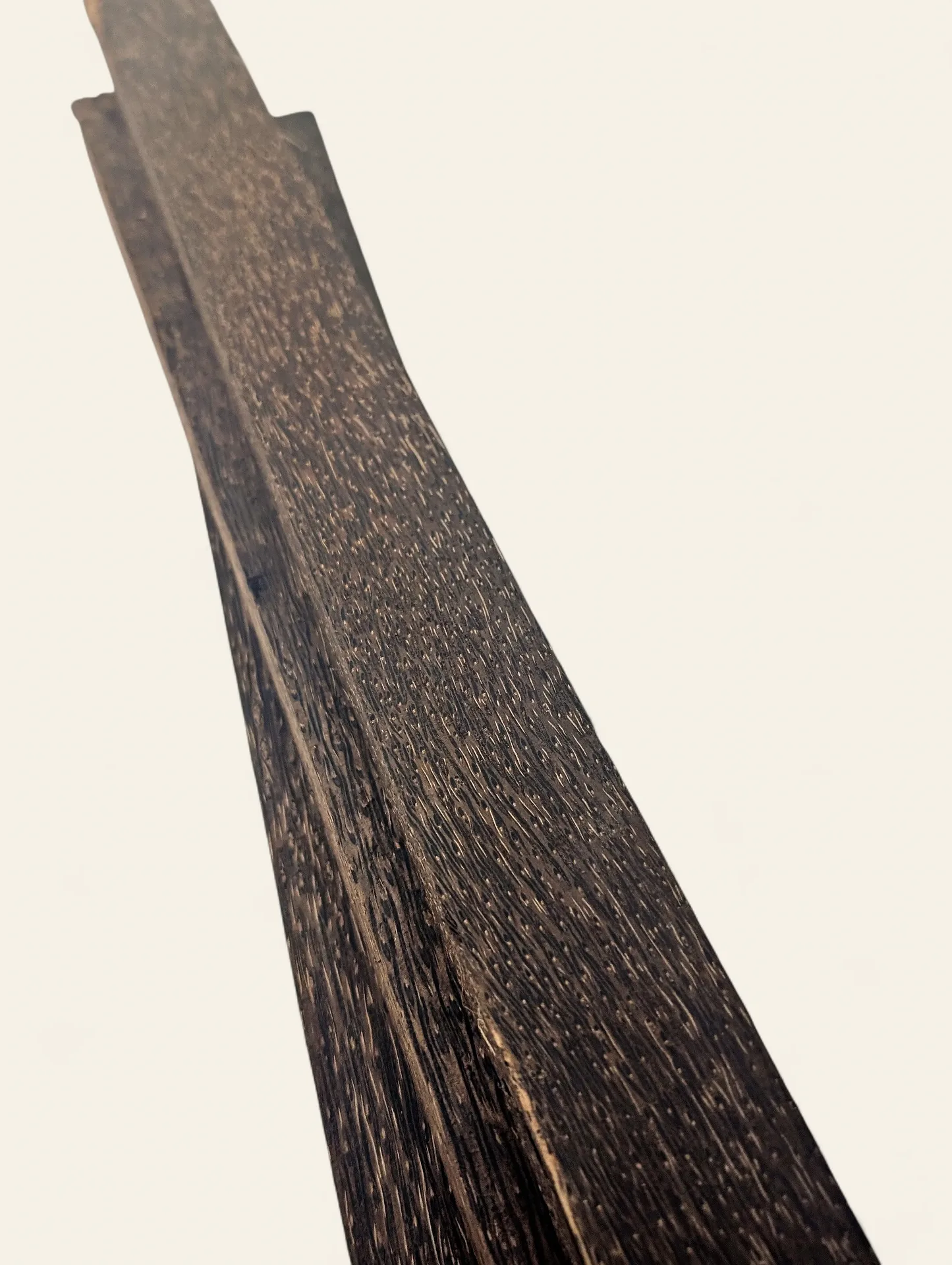 Black palm handle blank close-up grain detail