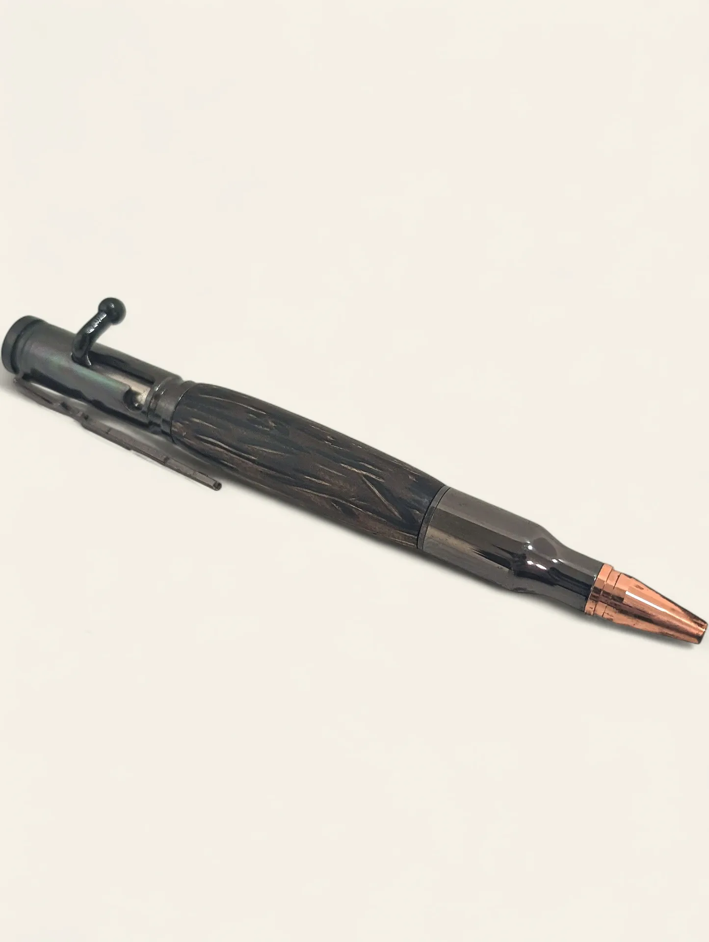 Turned pen made from black palm showing finished figure