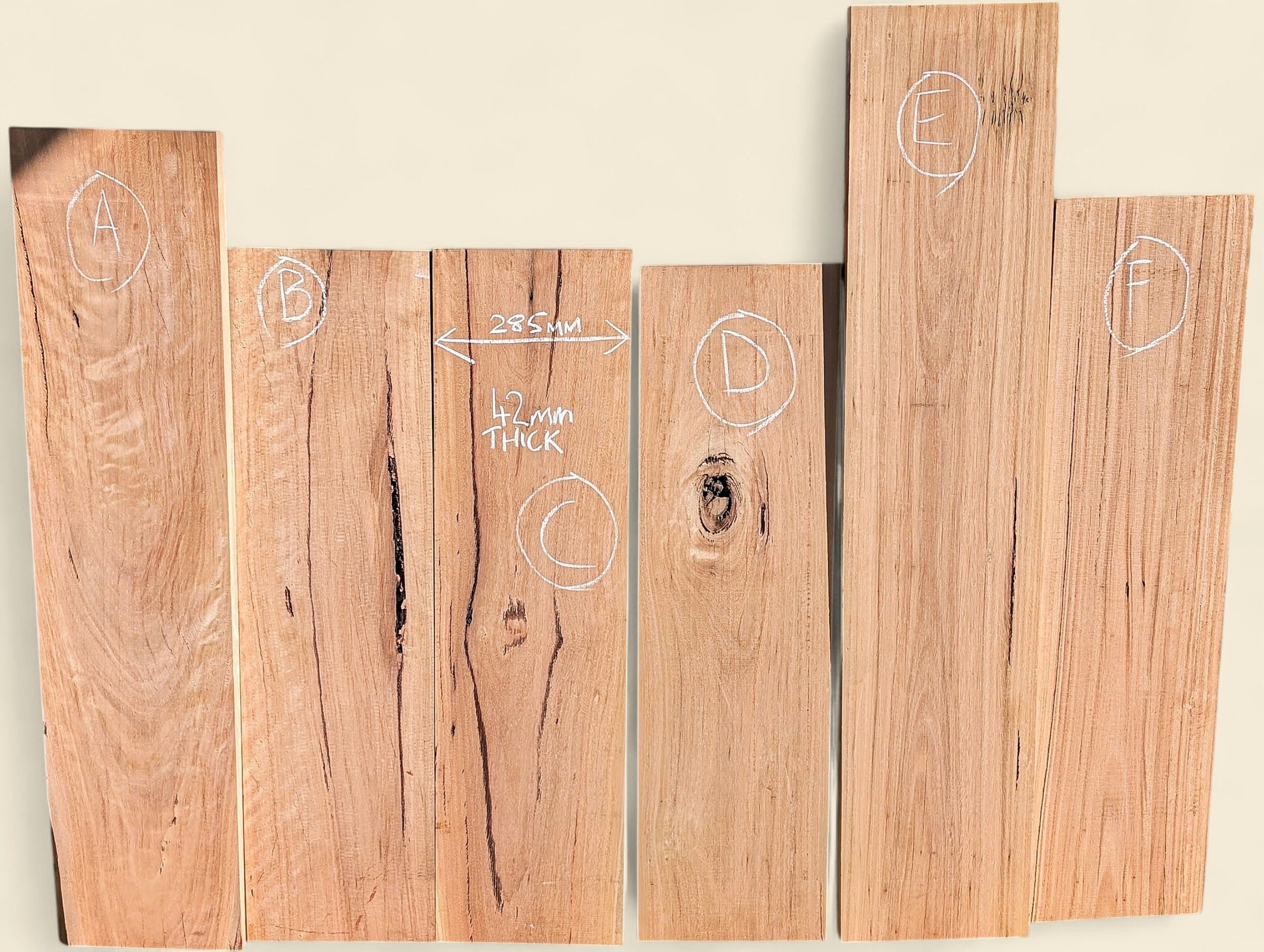 Six dressed Blackbutt boards, 285mm wide and 42mm thick, standing side by side