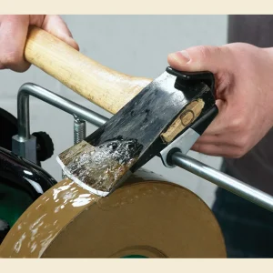 Record Power Axe Jig holding an axe head against the wheel of a WG250 wet stone sharpening system